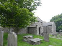 Oblique view of churchyard and entrance way of Church of St Giles, Bowes from left side May 2016